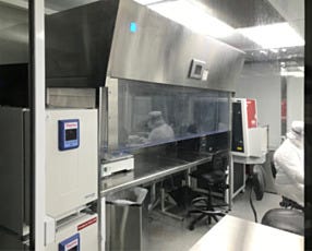 A free-standing laminar flow hood used in making implantable medical devices