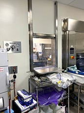 Vertical sliding convenience window pass-through for hospital lab