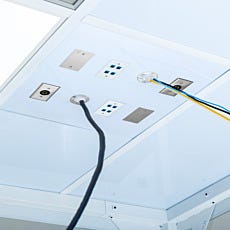 wall boots with cords of various sizes coming out of cleanroom ceiling