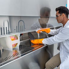 Stainless steel wet cleaning station with sink, gooseneck faucet, and spray gun