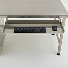 close up higher view of keyboard tray attached to workstation