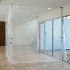 ipWall dust barrier poles supporting clear plastic sheeting in office construction containment area