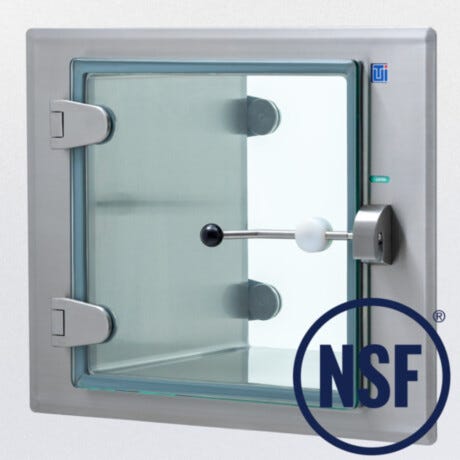 Closed full glass door with stainless steel hinges and latch arm on flush wall mounted BioSafe CleanMount pass-through