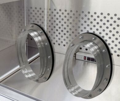 Stainless steel glove ports with ergonomic oval design, installed to laboratory glovebox  |  1672-10-2 displayed