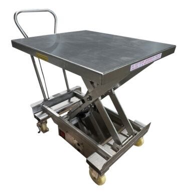 Stainless steel portable hydraulic lift table in raised position showing scissor mechanism, rectangular platform with safety labels, push handle, and mobile cas  |  1735-08 displayed