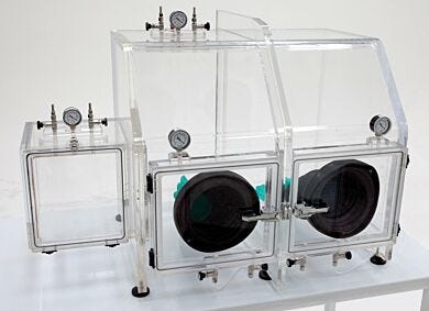 The Series 210 Vacuum Glovebox supports drying, degassing; includes valves for inert gas back-fill (shown with optional gloves and left-side air lock)  |  3306-89 displayed