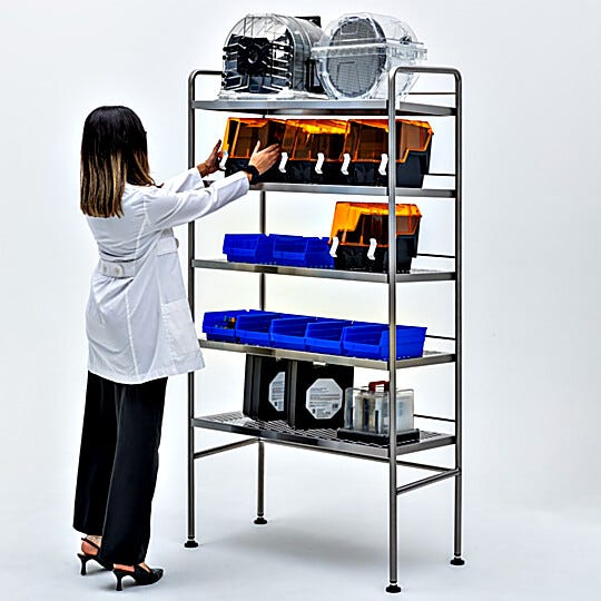 Stainless steel storage rack wth rear retaining bar and side flanges to prevent items from sliding off of the 5 rearward sloping shelves  |  9611-31B displayed
