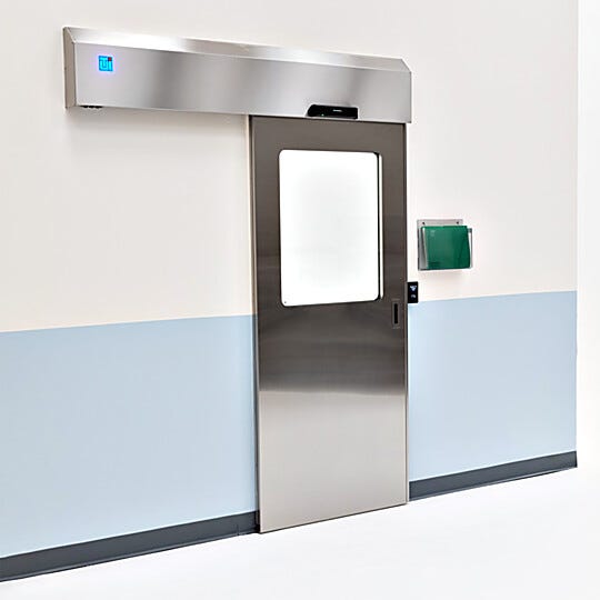 Partial view stainless steel automatic sliding door with touchless motion door pad  |  5556-13-LS displayed