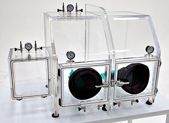 The Series 210 Vacuum Glovebox supports drying, degassing; includes valves for inert gas back-fill (shown with optional gloves and left-side air lock)  |  3306-89 displayed