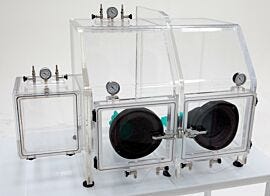 The Series 210 Vacuum Glovebox supports drying, degassing; includes valves for inert gas back-fill (shown with optional gloves and left-side air lock)  |  3306-89 displayed