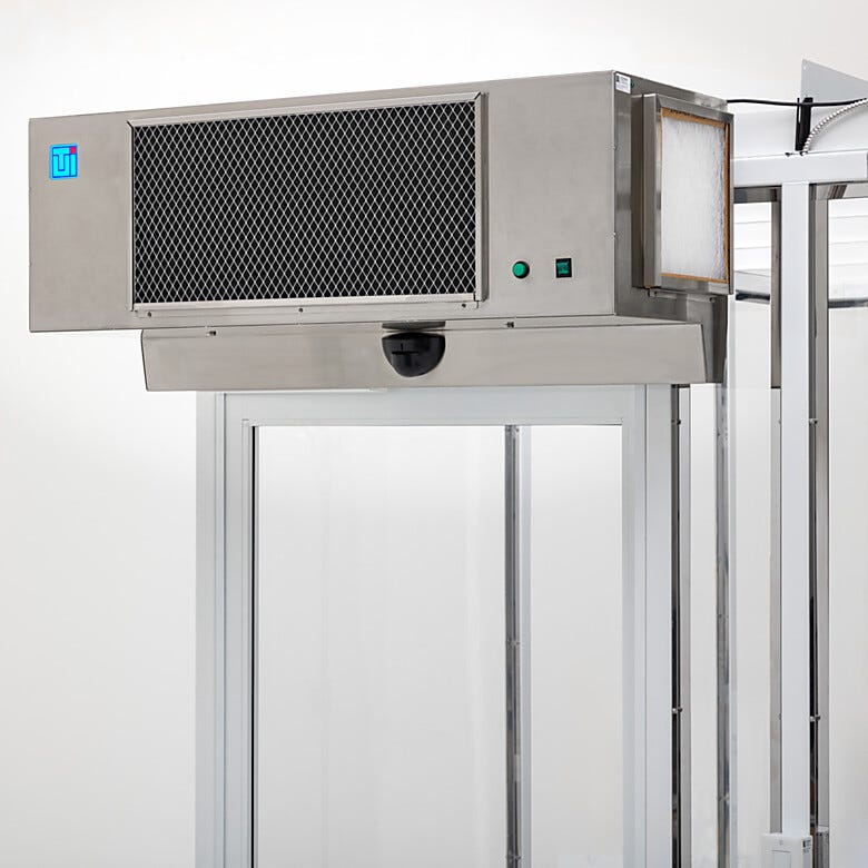 High-Velocity Cleanroom Air Curtain (stainless steel) shown installed on Terra’s Hardwall Cleanroom | 6601-50A displayed