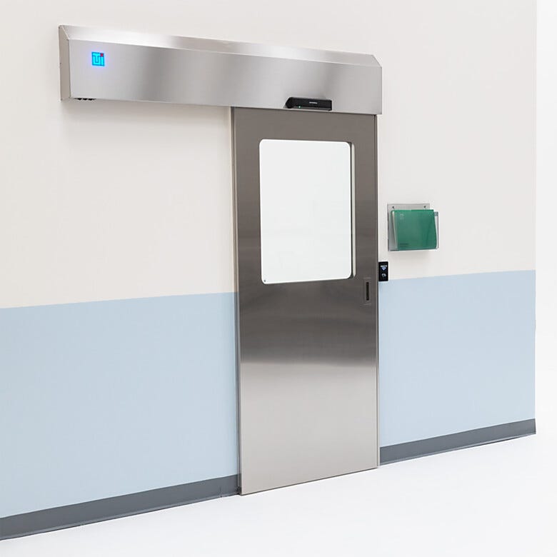 Partial view stainless steel automatic sliding door with touchless motion door pad  |  5556-13-LS displayed