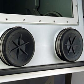Shown are exterior glove port covers placed over gloveports on a Labconco glovebox. | 3643-51 displayed