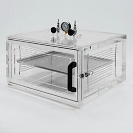 Clear acrylic vacuum desiccator cabinet with front swing door, shelving, vacuum gauge and needle valves | 5235-81 displayed