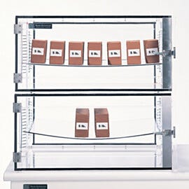 Acrylic shelves with bow guards, top, support 35 lbs. (16 kg); bowing apparent without bow guards, bottom, with load of 10 lbs | 1976-01 displayed
