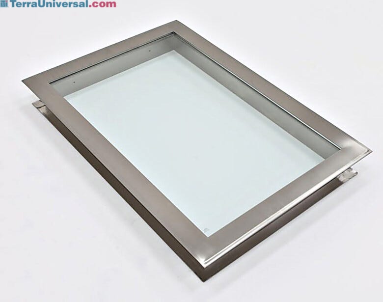 Flush-mounted stainless steel frame holds single tempered-glass window pane with CleanSeam ledge on opposite side.