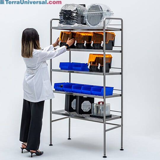 Stainless steel storage rack wth rear retaining bar and side flanges to prevent items from sliding off of the 5 rearward sloping shelves  |  9611-31B displayed