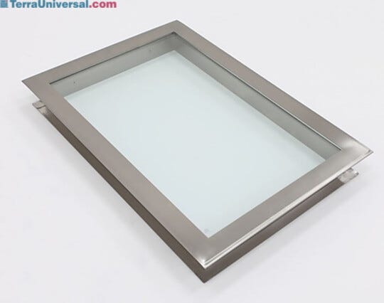 Flush-mounted stainless steel frame holds single tempered-glass window pane with CleanSeam ledge on opposite side.
