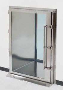 Floor-mounted pass-through chamber with swing-out door