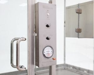 Control panel with pressure gauge and power switches for lights and fan/filter units.